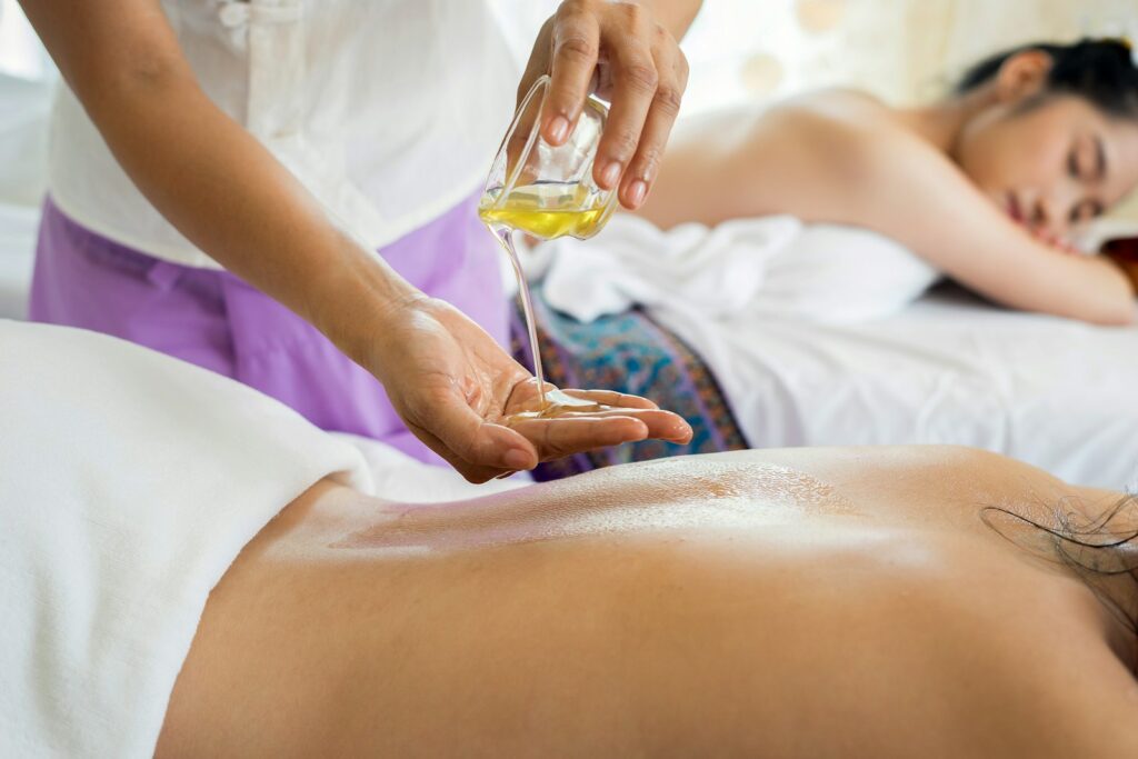 Therapist applying warm massage oil during a relaxing massage